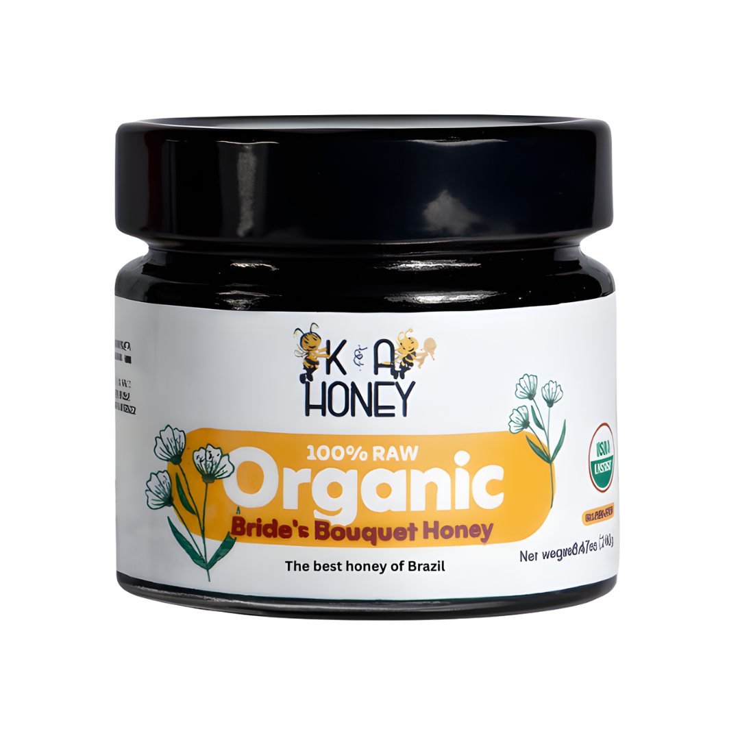 Jar of K&A HONEY labeled '100% RAW Organic Bride's Bouquet Honey' with USDA Organic certification; white label with floral and bee illustrations, black lid, emphasizing Brazilian origin and natural quality.